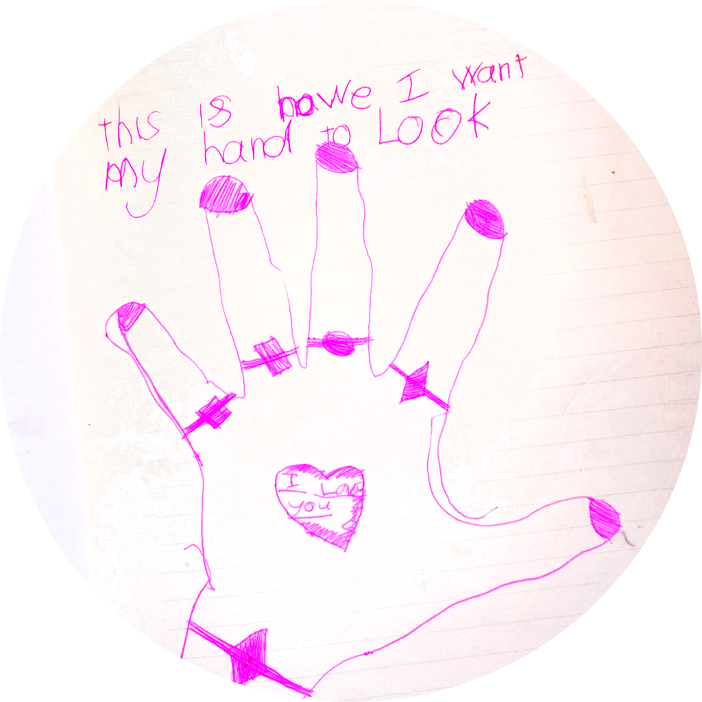 A tracing of a child-sized hand done in bright pink pen has hand-drawn jewelry and "I love you" written on the back of the hand.  A caption written in youthful scrawl reads, "this is how I want my hand to look" 